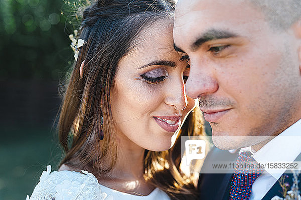 Close up of intimate newlyweds hugging each other with a lovely smile
