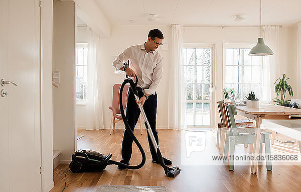 businessman cleaning his home before working from home