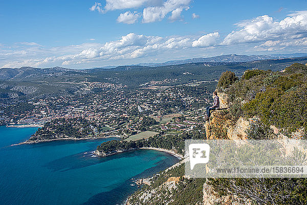 a men on a cliff facing the mediterranean sea (1)