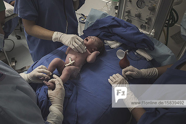 First moment of a newborn  labor in a hospital. After birth.