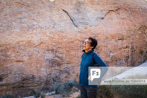 Portrait of a senior Asian woman in the desert rock landscape