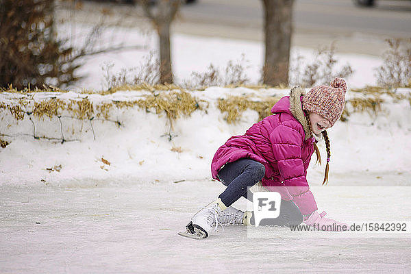 Little Girl Falling While Ice Skating