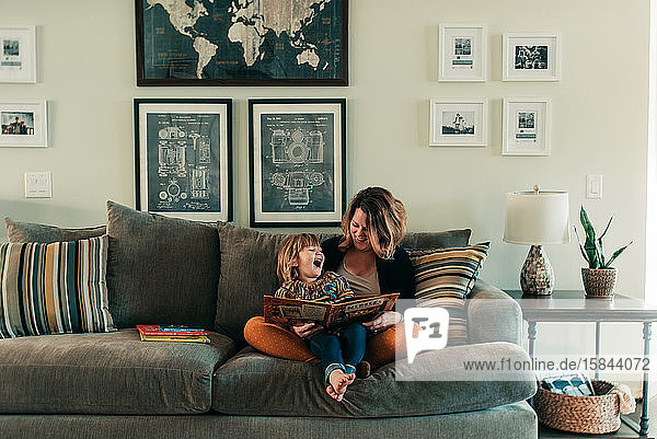 mother and young daughter reading
