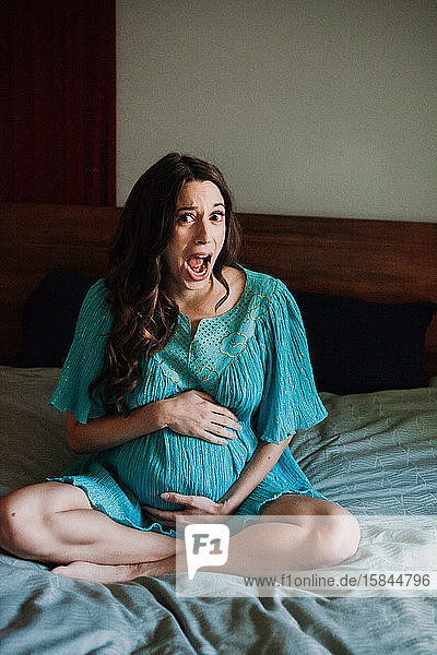Pregnant Woman in bed funny face