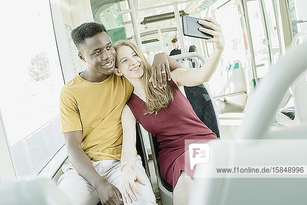 Verliebter Junge und verliebtes Mädchen nehmen einen Selfie im Bus
