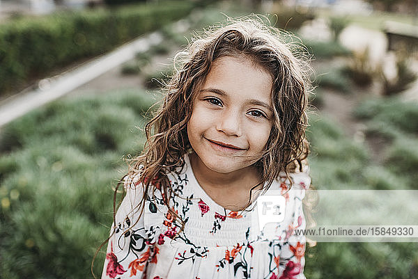Close up portrait of young school-aged confident girl smiling at