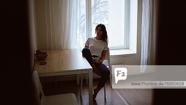 Porträt einer Frau  die auf einem Stuhl sitzt