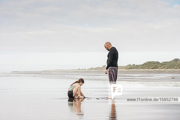 Father and daughter playing at the beach