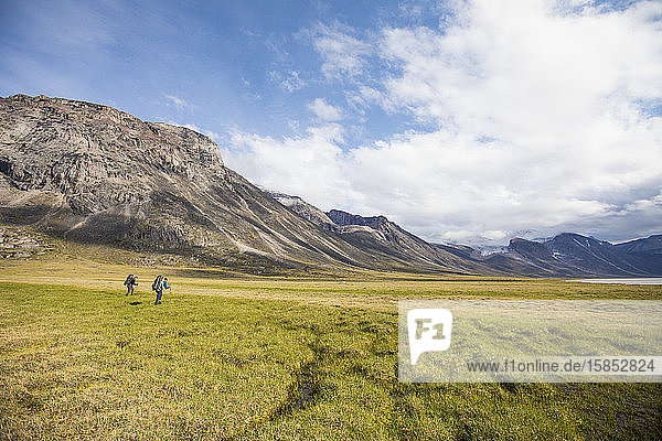Backpackers hiking in Akshayak Pass  Auyuittuq National Park.