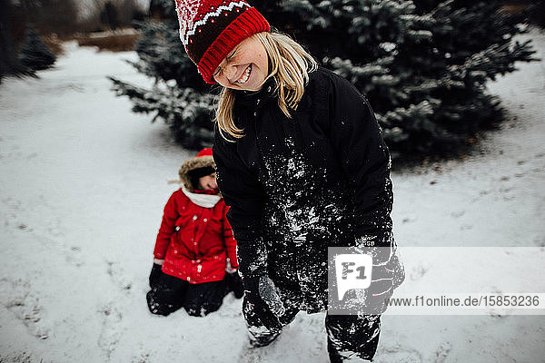 Young girl laughing while playing in the snow
