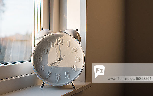 a large alarm clock sat on a window ledge of a home