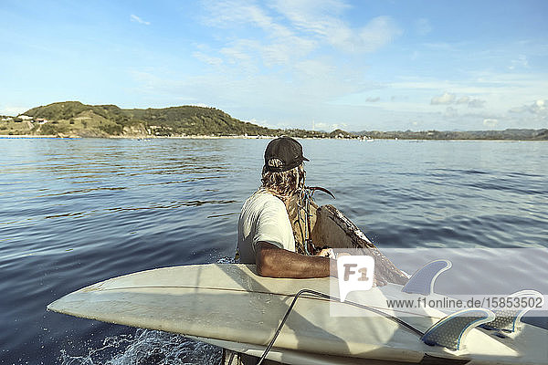 Unbekannter Surfer fährt Boot bei Sonnenschein