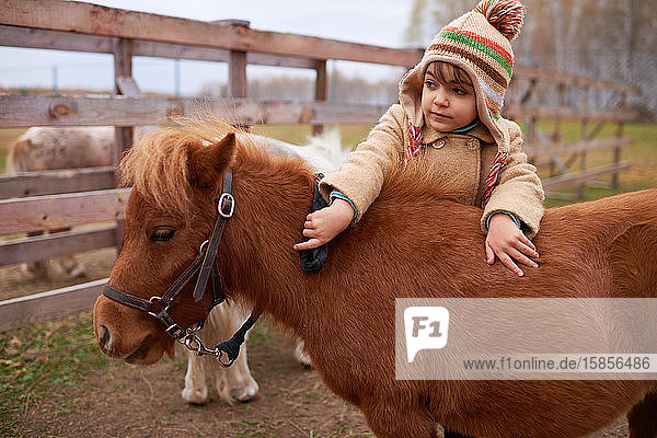 Little Child Spending Time On Horse Farm