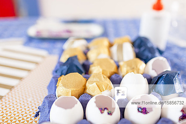 Close-up multi color confetti and eggshells over cloth table