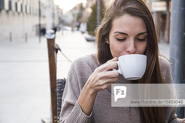Woman drinking a cup of coffee in Boadilla del Monte