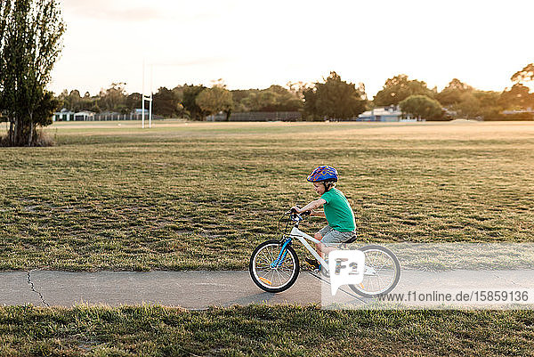 Young child riding bike on path