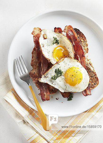 Two Eggs Sunny Side Up Bacon and Toast