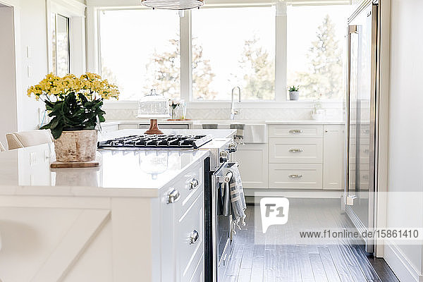 Bright white kitchen island with yellow flowers