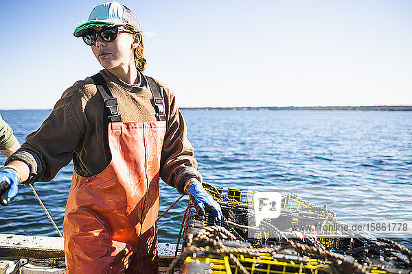 Woman working on shellfishing boat on Narragansett Bay