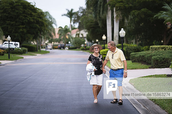Senior Couple walking hand in hand enjoying retirement