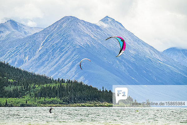 People kite surfing on Bennett Lake; Carcross Yukon Canada