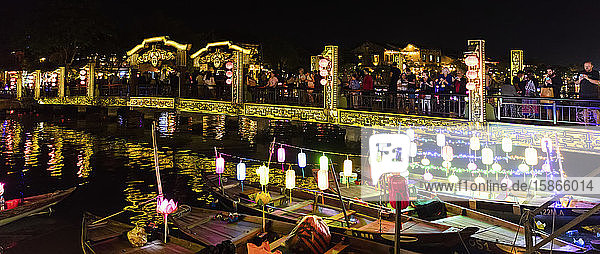 Bridge at nighttime with illuminated lanterns on boats; Hoi An Quang Nam Province Vietnam