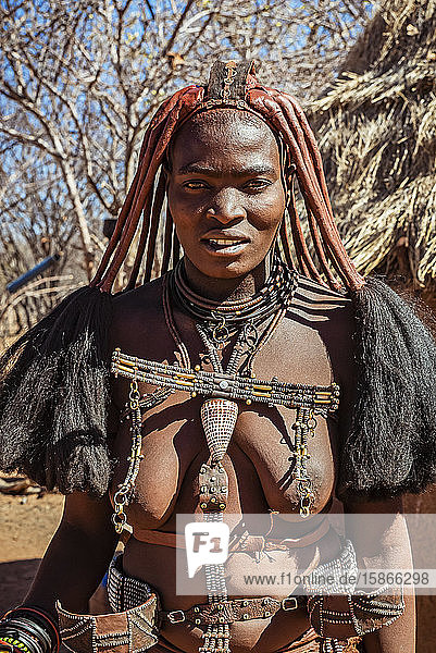 Himba woman wearing ornaments Himba village; Kamanjab Namibia