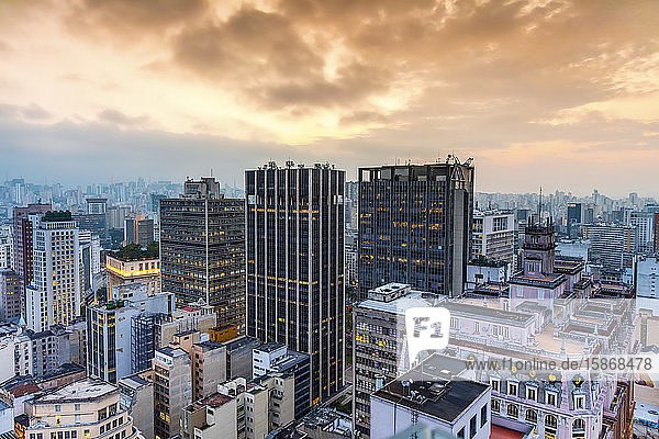 Skyscrapers under glowing orange clouds at sunset; Sao Paulo Sao Paulo Brazil