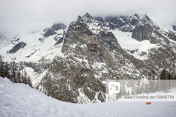 Caution sign in the backcountry below Mont Blanc at an alpine resort; Courmayeur Valle D'Aosta Italy