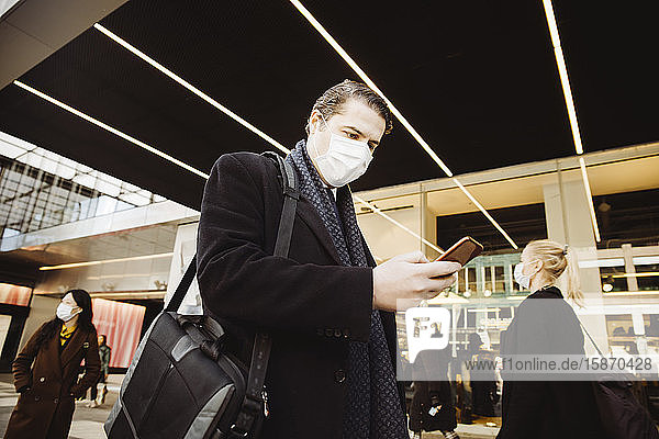 Man walkin in street wearing face mask