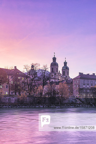 Cathedral of St. James is reflected in Inn River at sunrise Innsbruck Tyrol Austria Europe