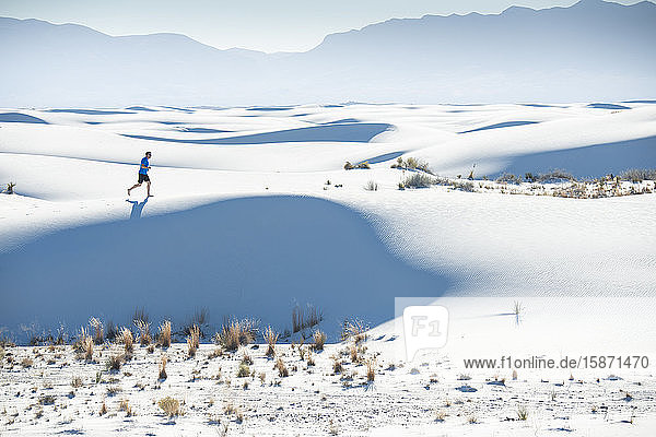 Jogging along a dune's ridge in White Sands National Park  New Mexico  United States of America  North America