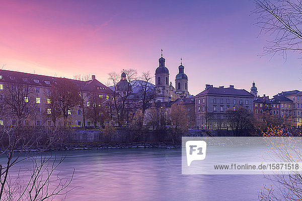 Cathedral of St. James is reflected in Inn River at sunrise Innsbruck Tyrol Austria Europe