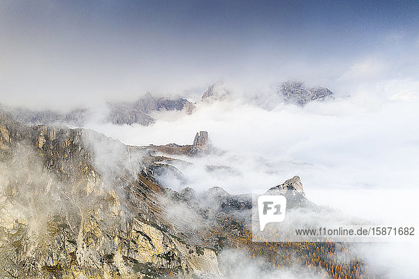 Aerial view of autumn mist over the trees and woods surrounding Cinque Torri and Tofane Giau Pass Dolomites Belluno Veneto Italy Europe