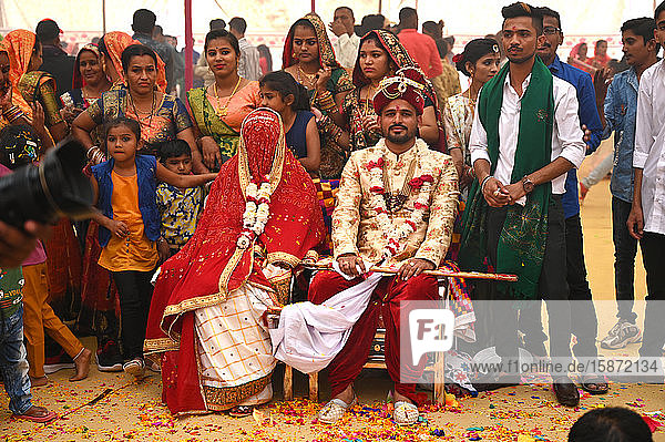 Bride and groom with guests at their wedding as part of tented multiple wedding ceremony  Bhuj  Gujarat  India  Asia