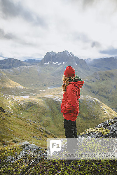 Young woman in red jacket on mountain