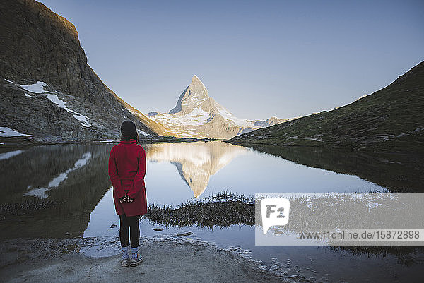 Woman standing by Matterhorn mountain and lake in Valais  Switzerland