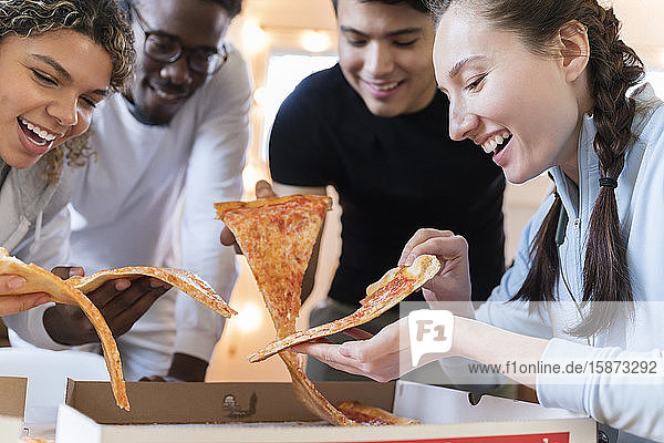 Group of friends having pizza together