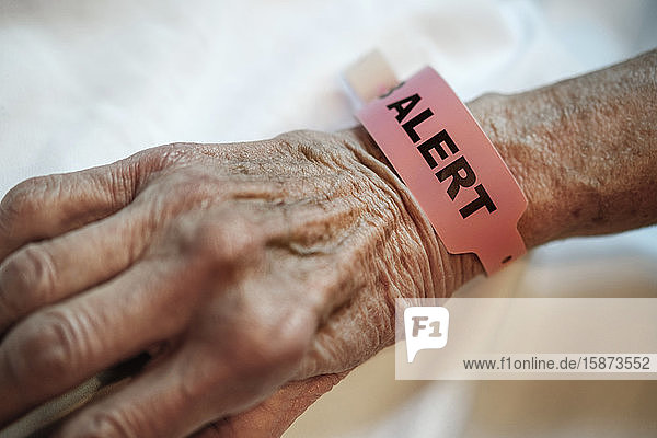 Alert tag around senior person's wrist