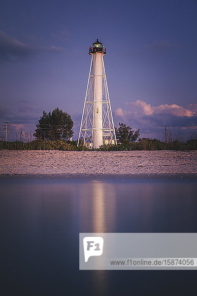 USA Florida Boca GrandeLighthouse reflecting in sea at night