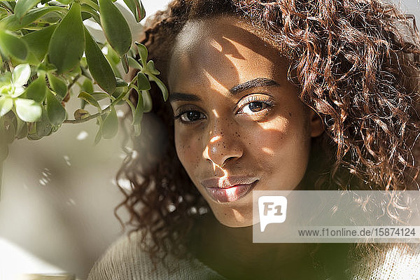 Woman in shadow by plant