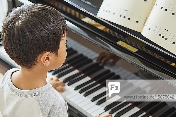 Japanese kid practicing piano