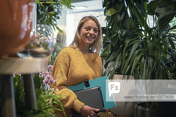 Young woman standing in flower shop