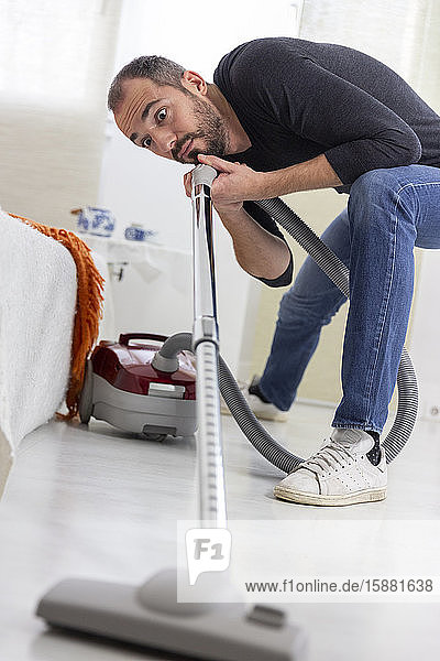 A man vacuuming.