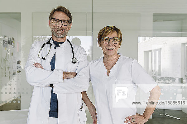 Porträt eines selbstbewussten Arztes und Assistenten in der medizinischen Praxis