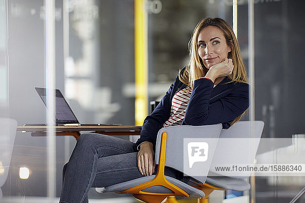Portrait of businesswoman with laptop in office
