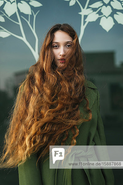 Porträt einer rothaarigen jungen Frau mit wehendem Haar