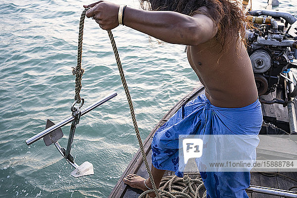 Young native man on a boat trip holding anchor  Ko Yao Yai  Thailand