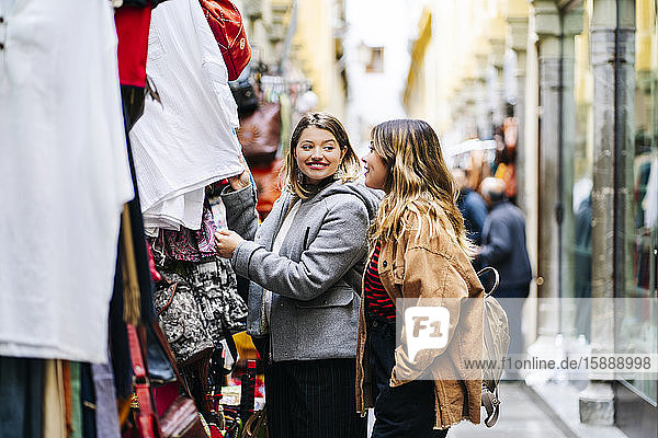 Two happy young women shopping in the city