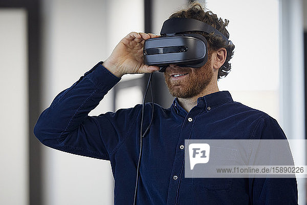 Businessman wearing VR glasses in office